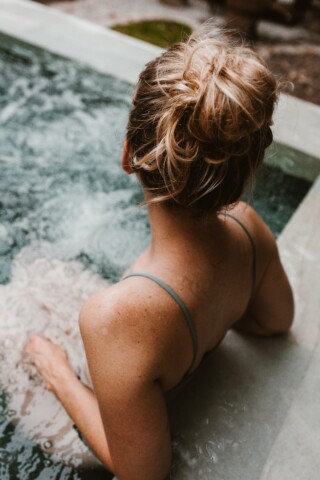 Woman sitting in hot tub.