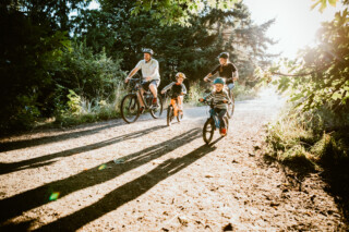 Family biking wooded trail.