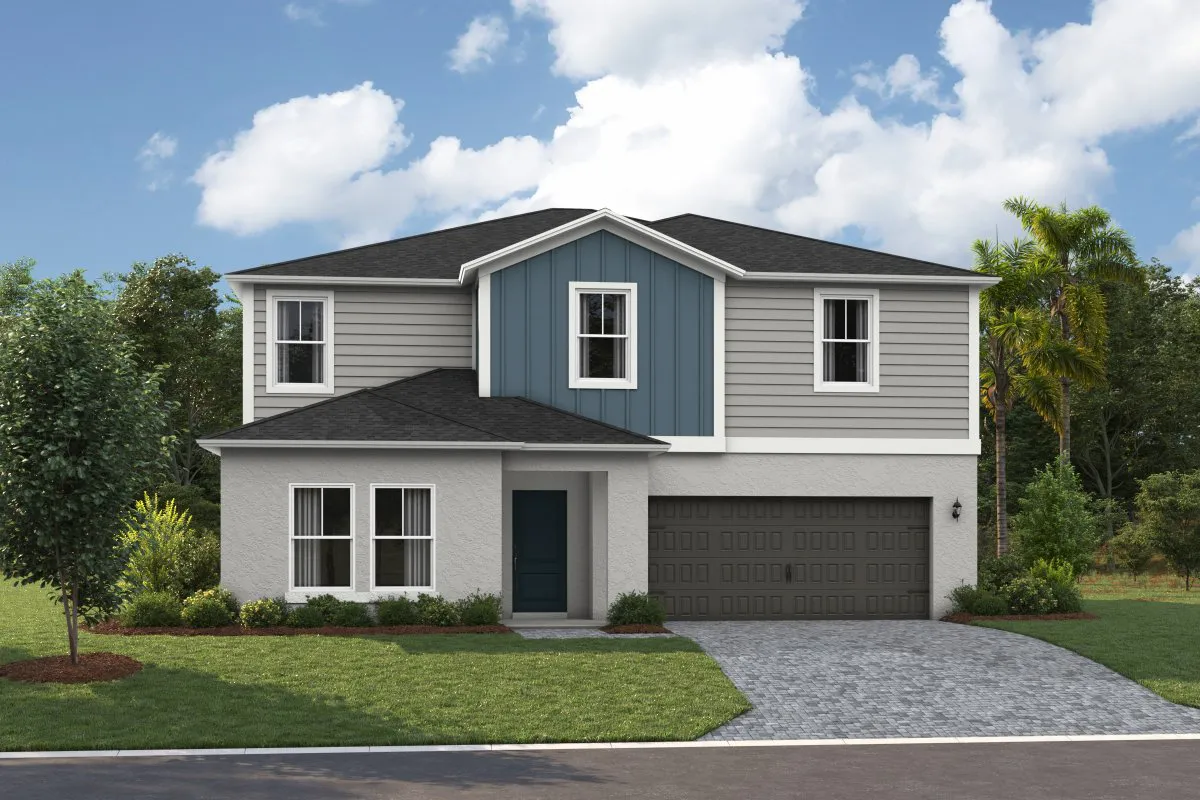 Two-story suburban house with gray siding, a prominent blue vertical accent on the upper level, dark shingle roof, double garage, front porch, and a well-kept lawn with small trees and bushes under a partly cloudy sky.