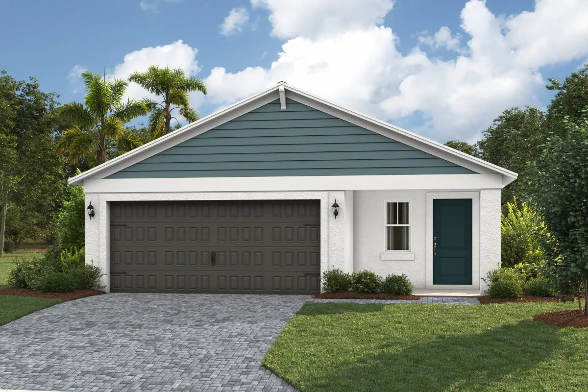 Single-story house with a dark double garage door, blue siding on the upper front, white walls, a single window, and a teal front door, surrounded by grass, trees, and a paved driveway under a partly cloudy sky.