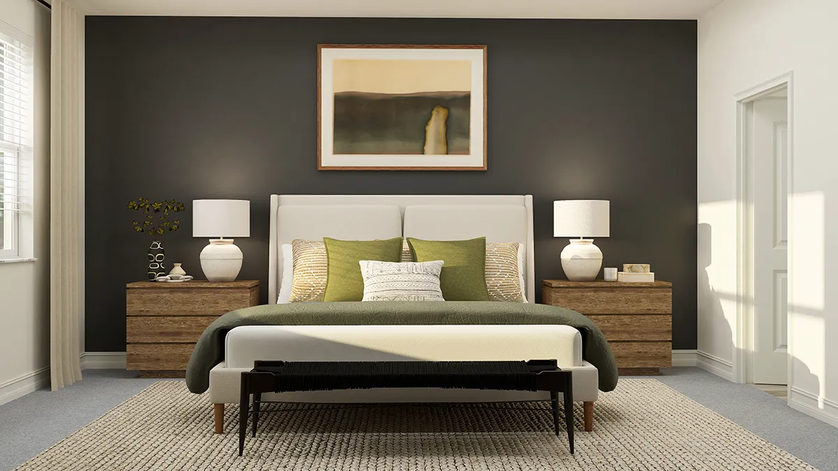 A modern bedroom with a white upholstered bed, green and neutral bedding, two wooden nightstands with white lamps, a dark accent wall, abstract wall art, and a woven rug on a light carpeted floor.