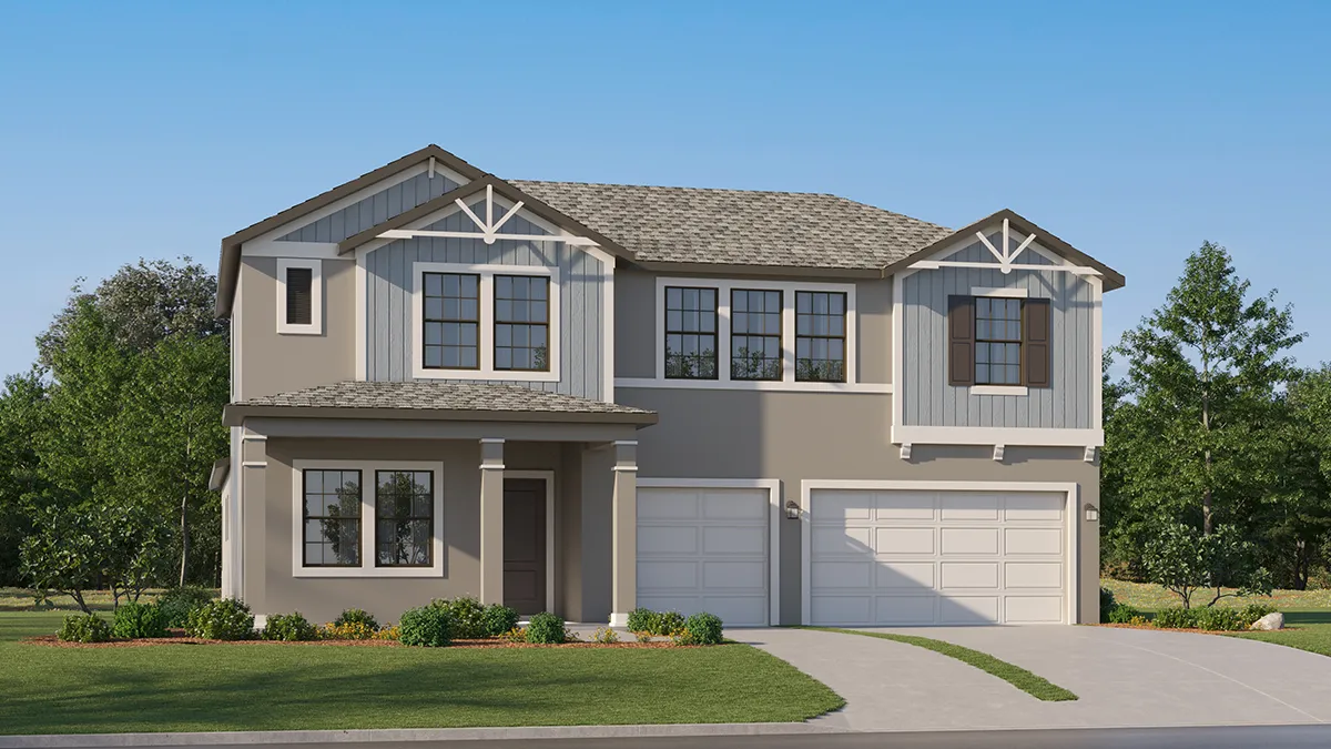A modern two-story house with gray siding, white trim, and a gable roof. It features a covered front porch, a double garage, a manicured lawn, and is surrounded by green trees under a clear blue sky.