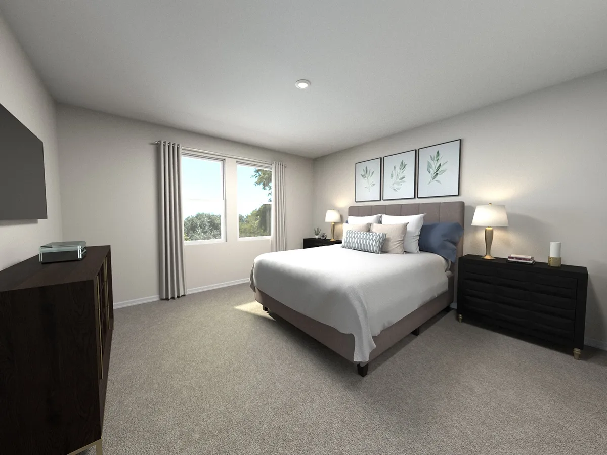 A spacious bedroom with a large bed, two bedside tables with lamps, wall art above the bed, a dresser with a TV, carpeted floor, and a window with beige curtains letting in natural light.