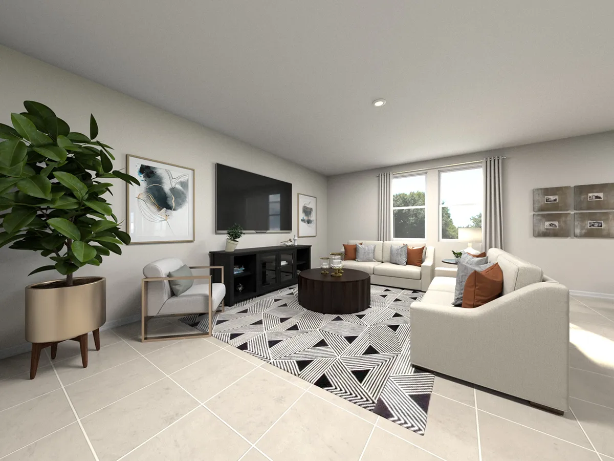 Modern living room with light-colored sofas, a patterned rug, a large TV on a dark console, a coffee table, wall art, a potted plant, and large windows letting in natural light. The floor is tiled in a light color.