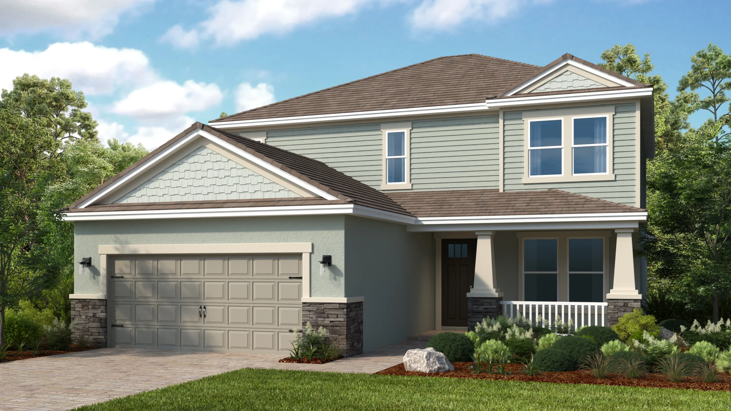 A two-story suburban house with gray siding, a double garage, front porch, stone accents, and landscaped yard, set against trees and a blue sky with clouds.