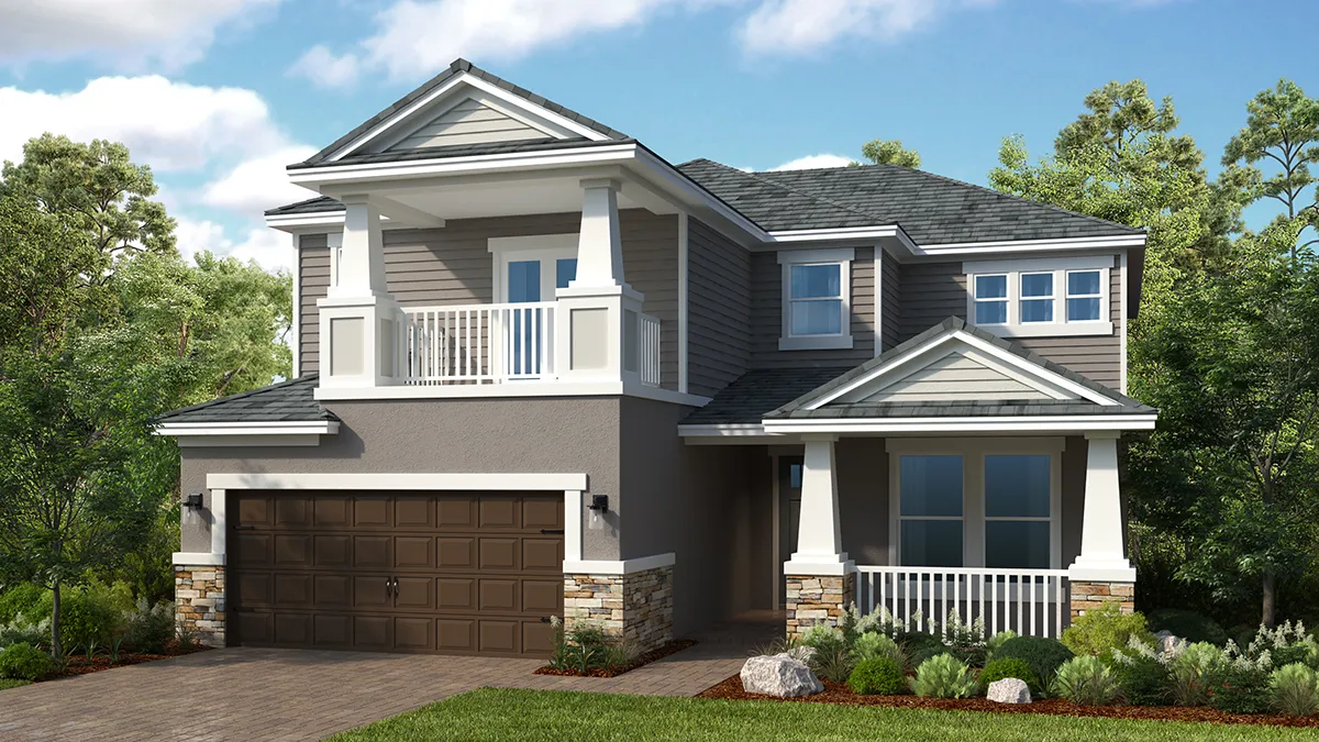 Two-story suburban house with gray siding, white trim, a covered front porch, balcony, and double garage. The yard has green grass, shrubs, trees, and a blue sky with scattered clouds in the background.