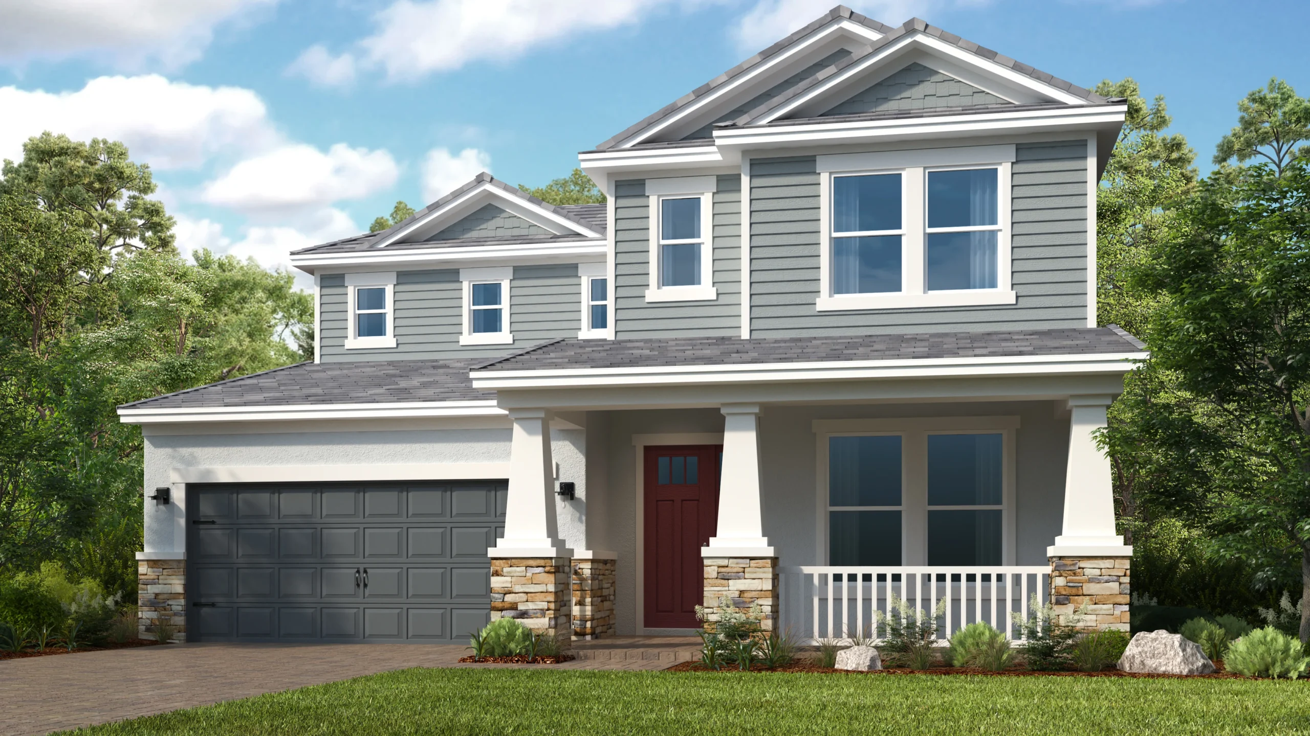 A modern two-story house with gray siding, white trim, a red front door, double garage, and covered front porch, surrounded by green grass, shrubs, and trees under a partly cloudy sky.