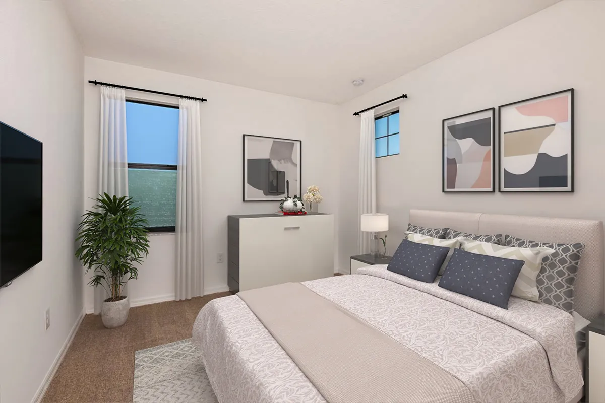 A modern bedroom with a neatly made bed, abstract art on the walls, a dresser with a lamp and decor, a potted plant, two windows with white curtains, and a wall-mounted TV. The room has beige carpet flooring.