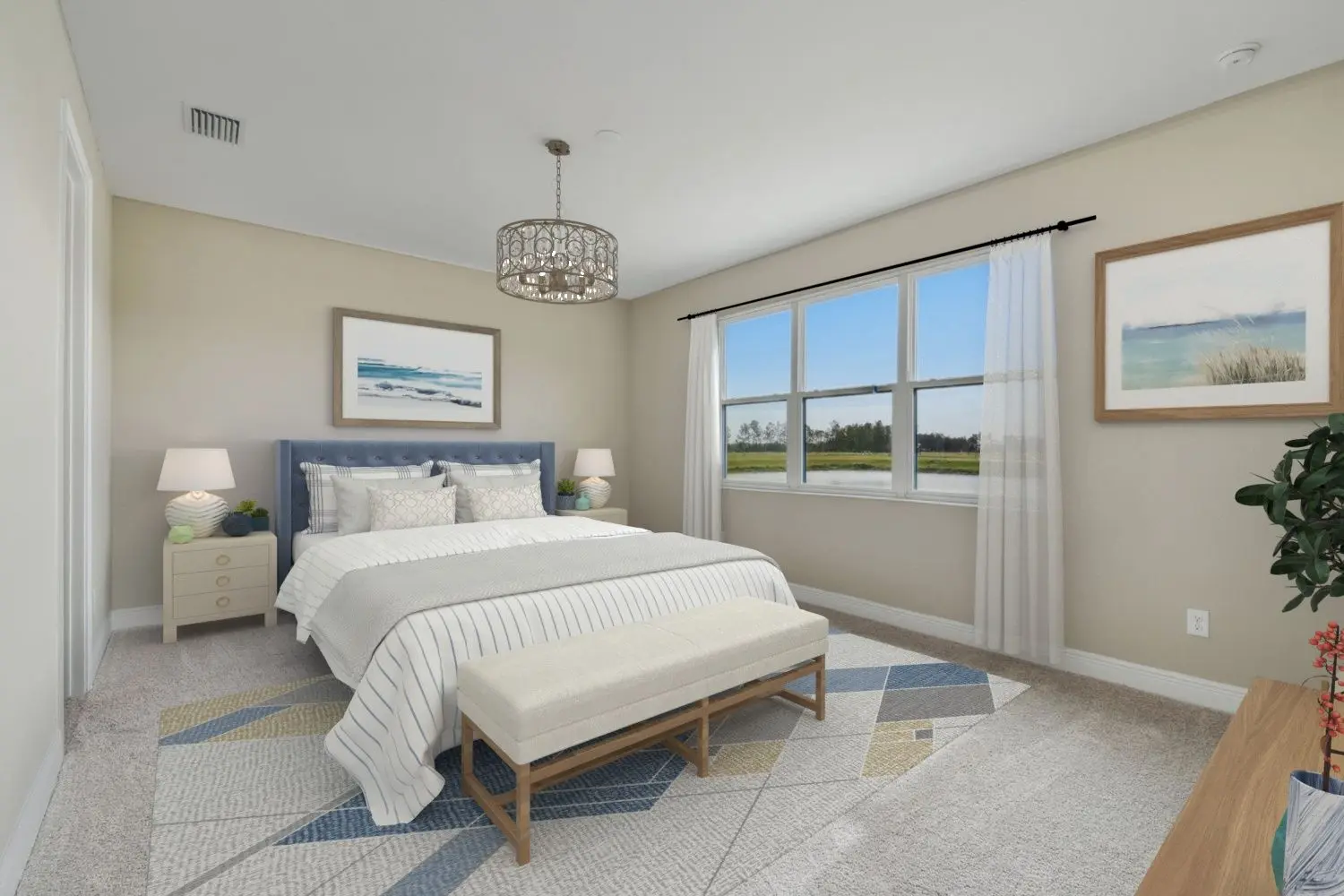 A bright, modern bedroom with a large bed, two nightstands with lamps, a patterned rug, a bench at the foot of the bed, and large windows letting in natural light. Artwork decorates the beige walls.