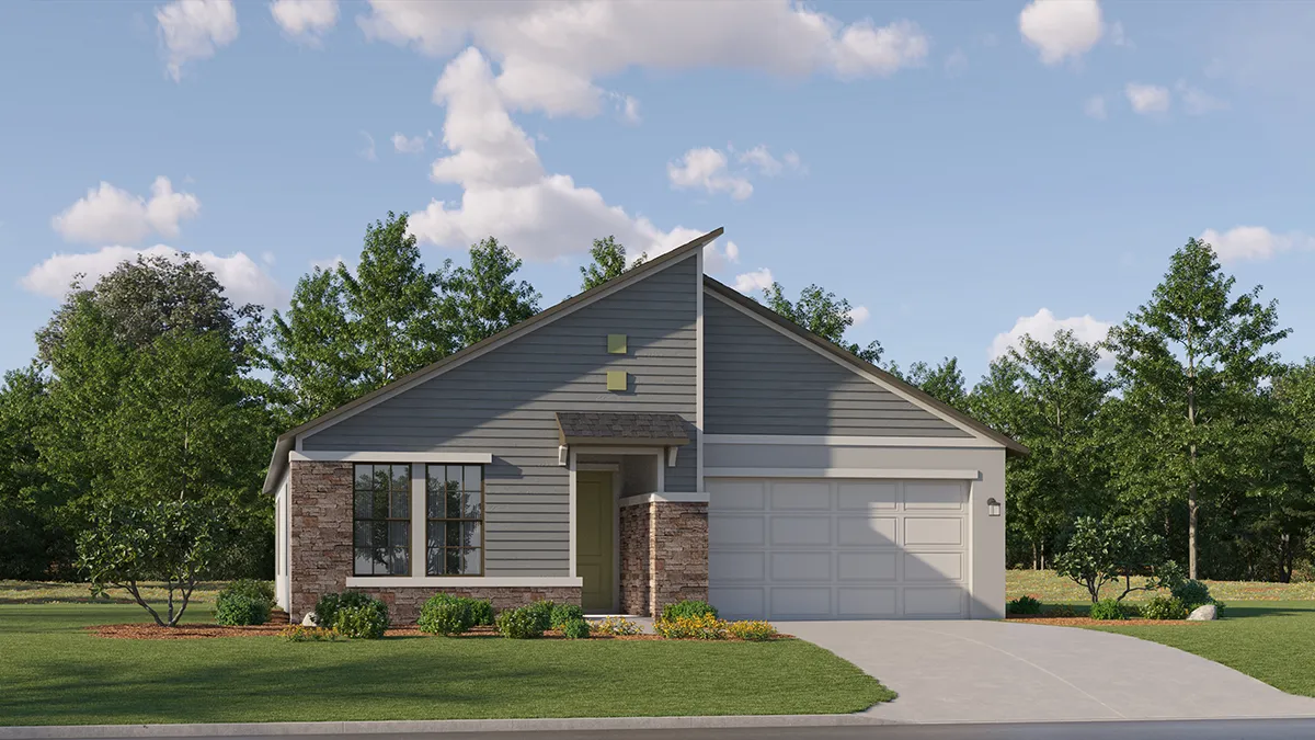 Single-story modern house with gray siding, brick accents, and a white two-car garage. Front lawn with shrubs and a driveway. Trees and blue sky with clouds in the background.