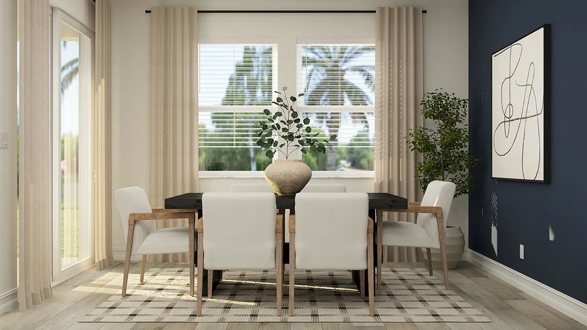 A modern dining room with a black table, six white chairs, a large vase with greenery, beige curtains, abstract wall art, a potted plant, and sunlight coming through two windows showing palm trees outside.