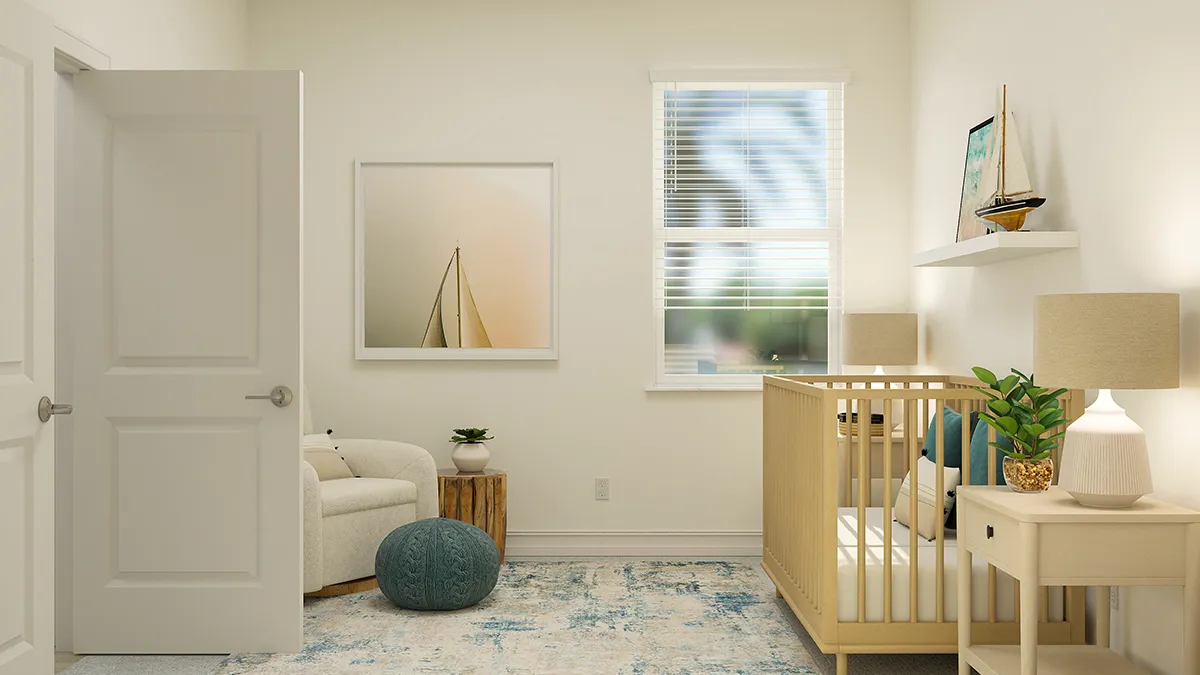 A cozy, light-filled nursery with a crib, an armchair, a pouf, a side table with a lamp and plant, a sailboat-themed wall art, and a window with white blinds. The decor is neutral and calming.
