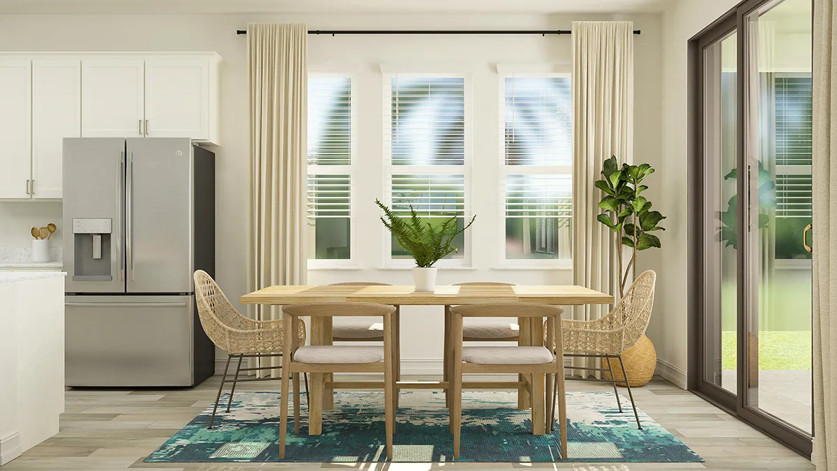 A modern dining area with a wooden table, six chairs, a blue-patterned rug, a potted plant, and large windows with beige curtains. A stainless steel fridge and sliding glass doors are visible in the background.
