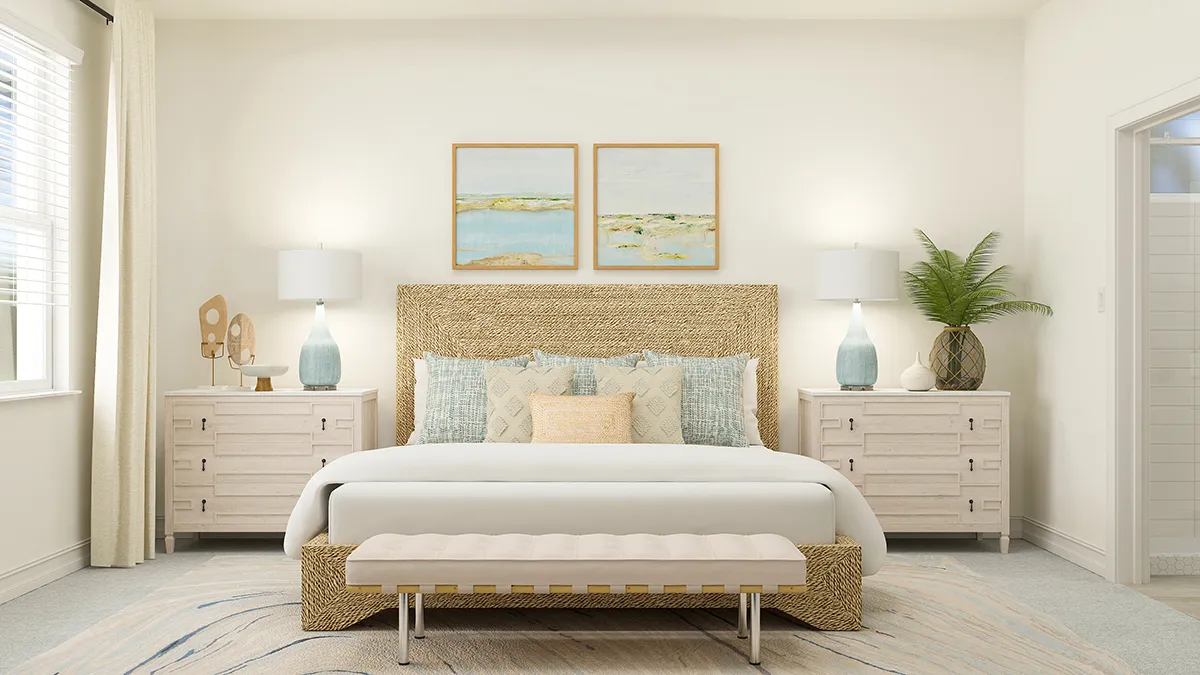A bright, airy bedroom with a woven bed frame, pastel bedding, light wood nightstands, matching lamps, modern art above the bed, a cushioned bench, and a large green plant, all in soft neutral tones.