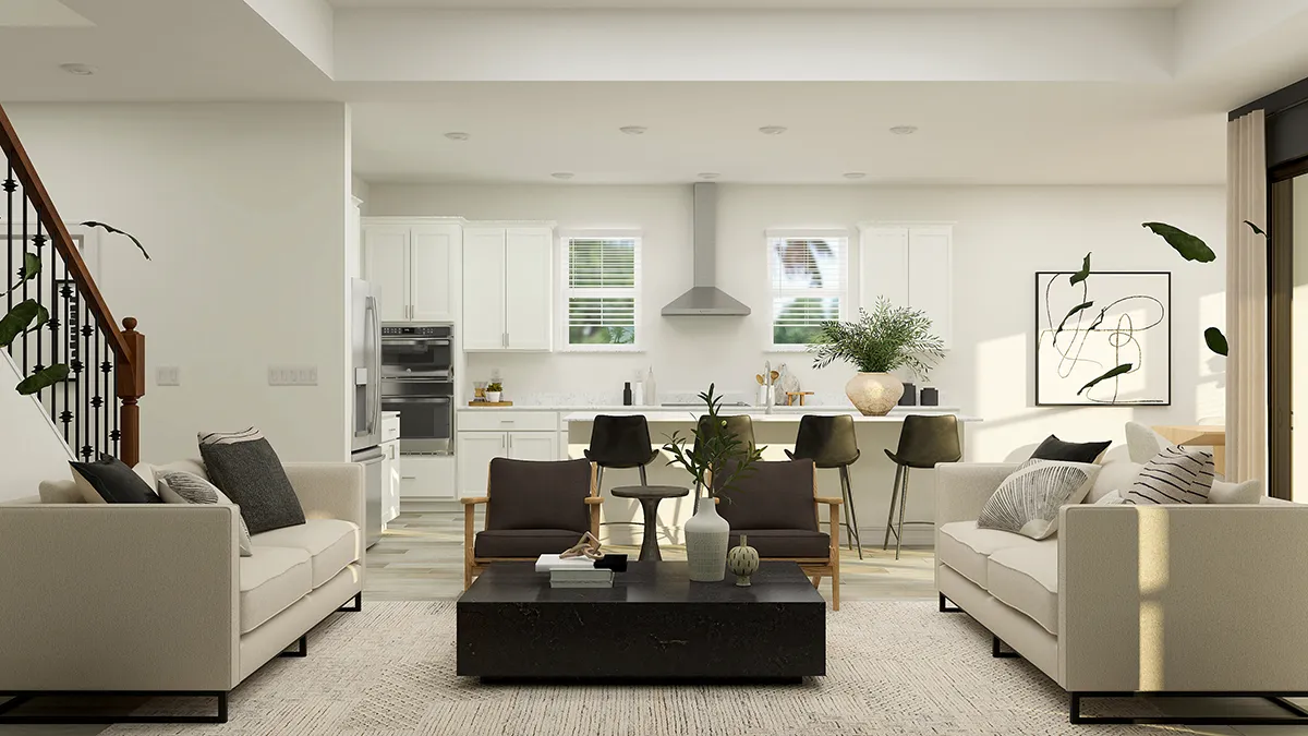 Modern open-concept living room and kitchen with neutral tones, two beige sofas, black armchairs, a black coffee table, barstools at a kitchen island, and large windows letting in natural light.