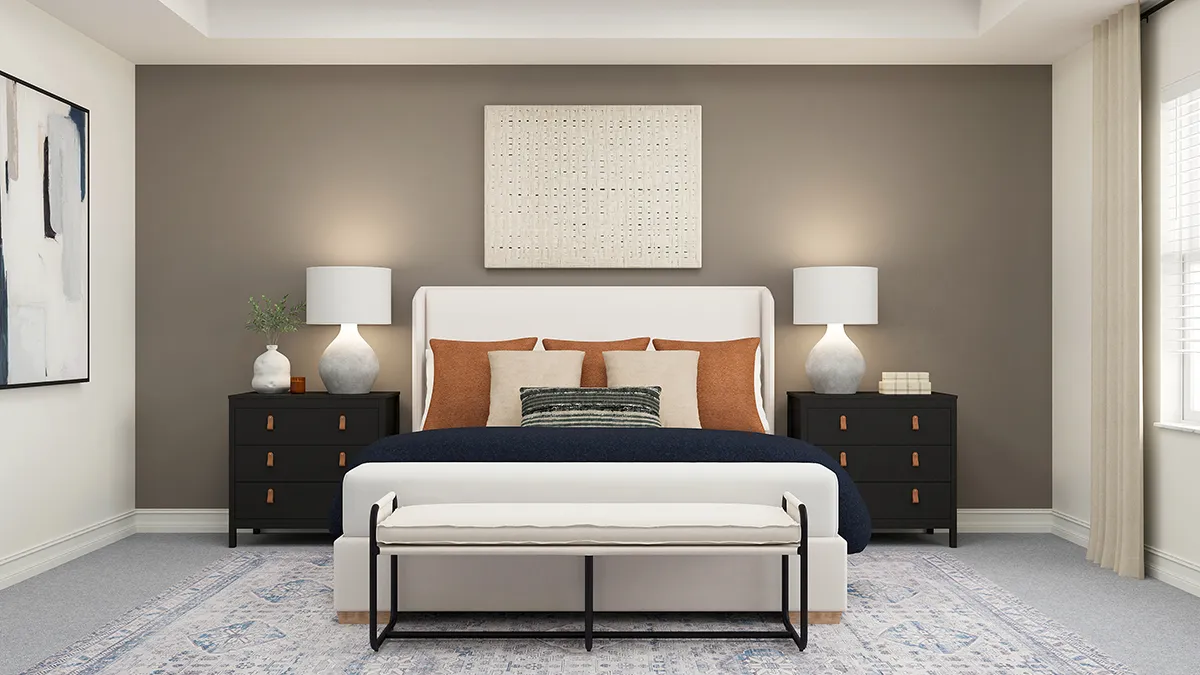 Modern bedroom with a white upholstered bed, orange and neutral pillows, black nightstands with lamps, abstract wall art, a bench at the foot of the bed, and large window with light curtains.