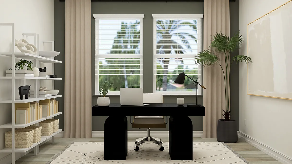 A modern home office with a black desk, office chair, laptop, desk lamp, and potted plant by the window. Beige curtains frame two large windows showing palm trees outside. Shelves with books and decor are on the left.
