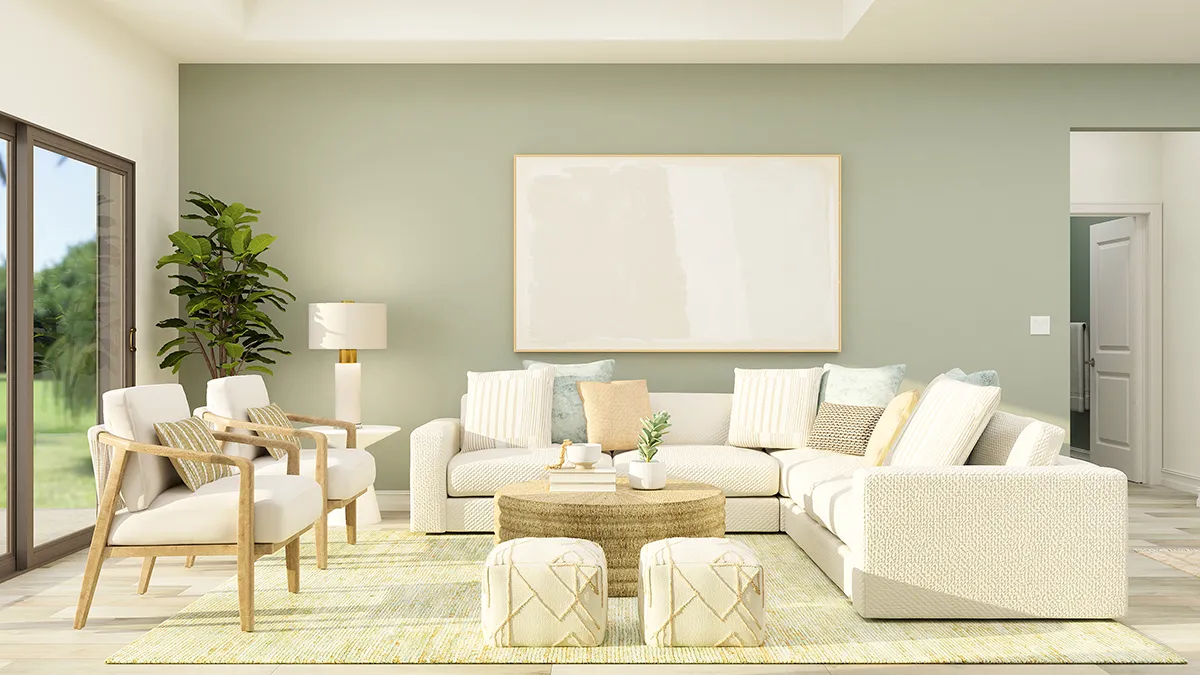 A bright, modern living room with light-colored sofas, armchairs, two ottomans, a round coffee table, a large empty frame on a pale green wall, houseplants, and a sliding glass door letting in natural light.