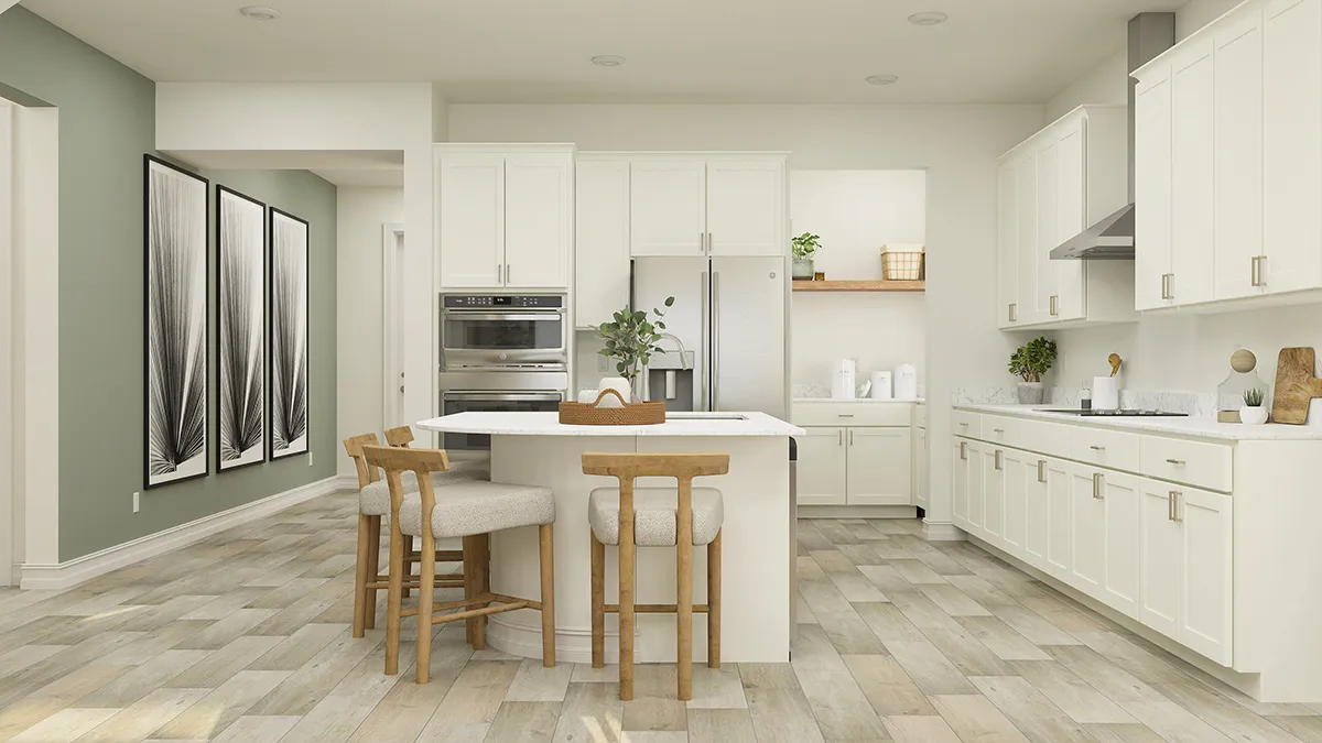 Modern kitchen with white cabinets, a central island with two wooden chairs, stainless steel appliances, light wood flooring, and minimalistic decor. Three abstract black-and-white artworks hang on a green accent wall.