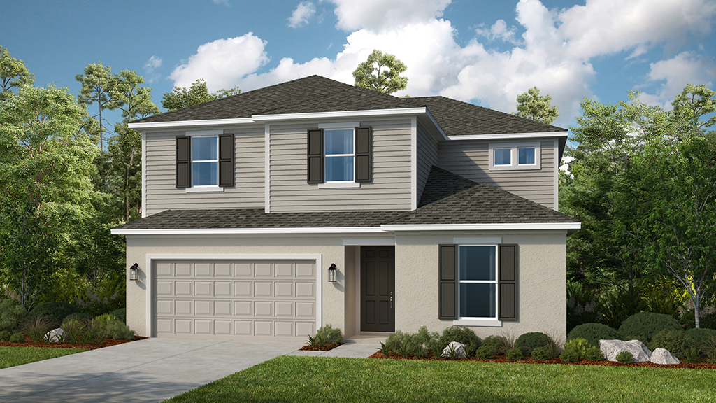 A two-story suburban house with beige siding, dark shutters, a double garage, and a small front yard with shrubs, surrounded by trees under a partly cloudy sky.